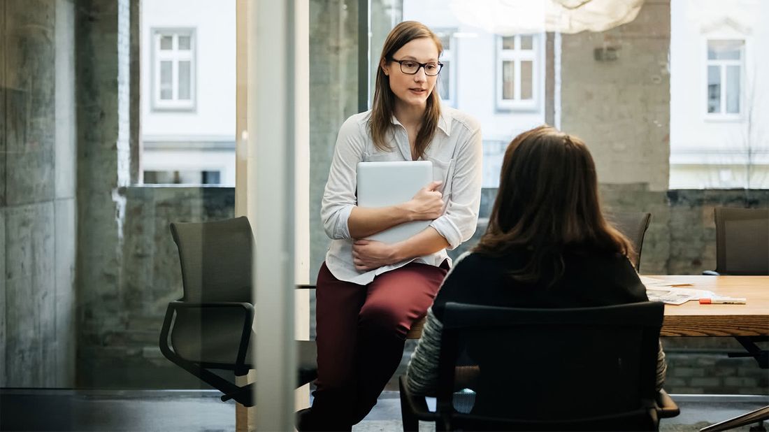 Two women talking about how to negotiate salary