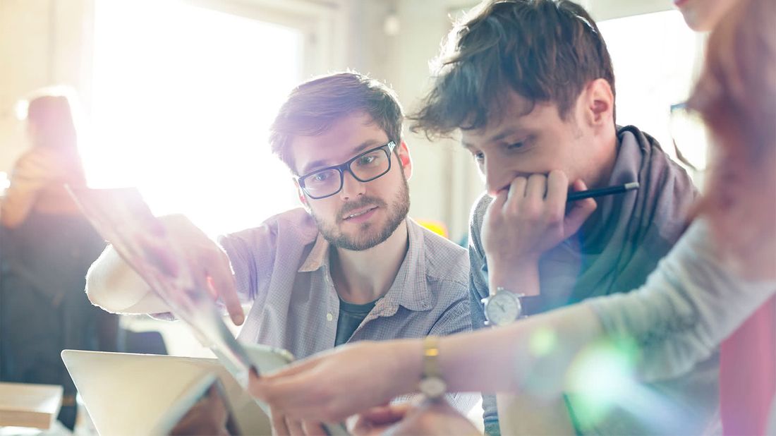 Newly hired coworkers discussing job benefits