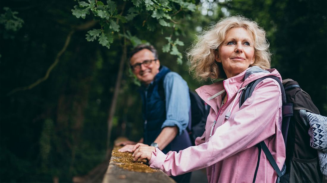 Older couple hiking after getting a senior discount on gear