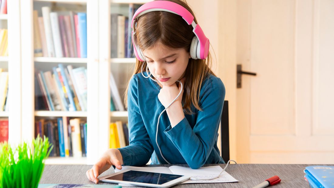 Young girl doing online learning through educational websites and apps for kids