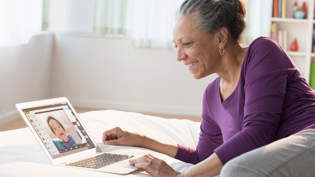 Grandmother staying connected with grandson over video conferencing while social distancing.