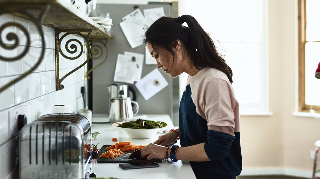 A young woman preparing a meal during coronavirus quarantine