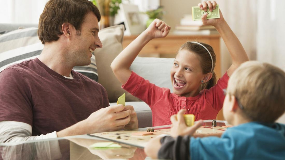 Family playing financial board game