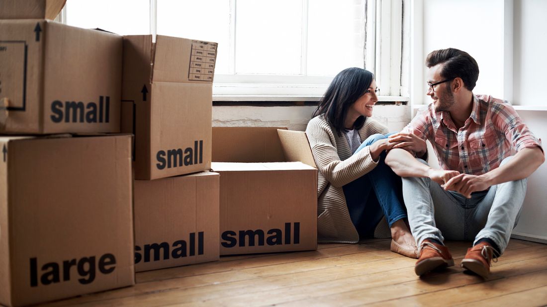 couple sitting with moving boxes