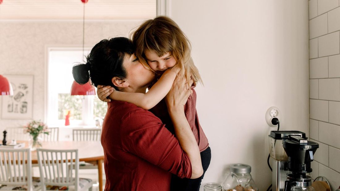 Mom and daughter embracing while quarantining