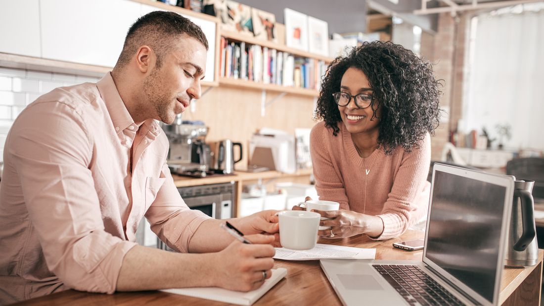 couple working on finances in kitchen