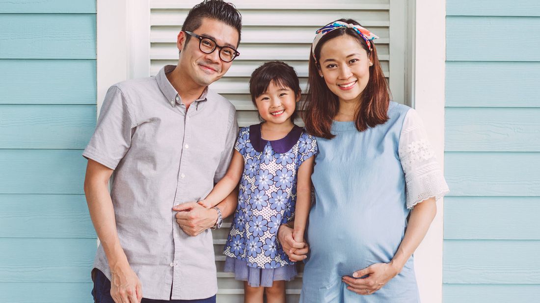 Young family posing for a picture.