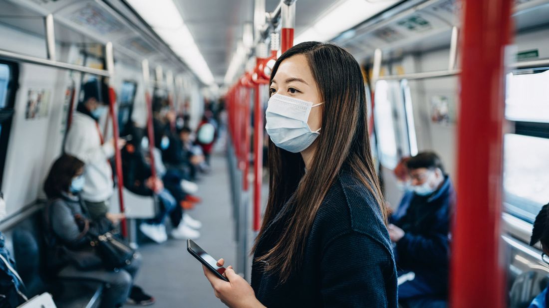 A woman checking her account on a subway