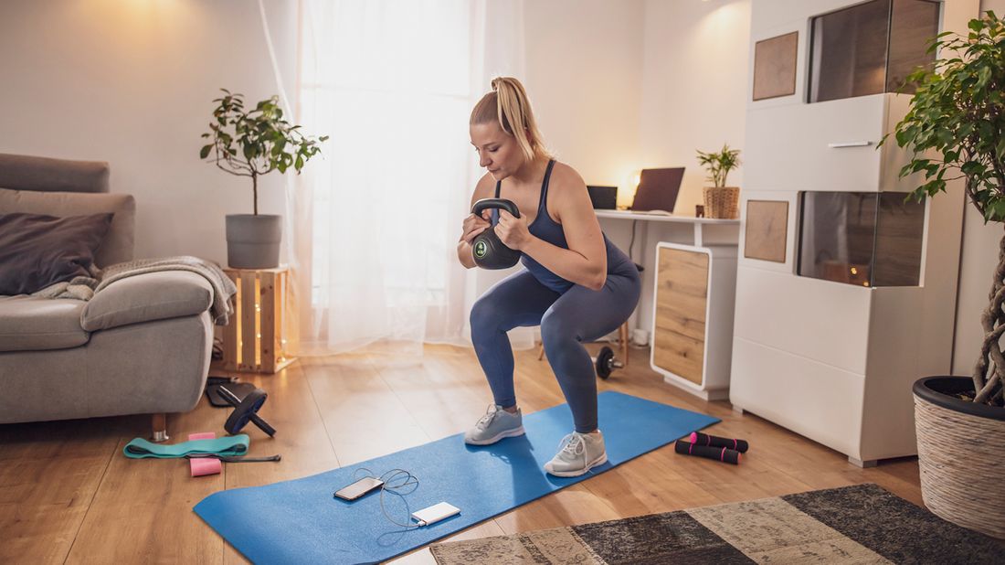 Woman staying motivated to work out at home while social distancing.