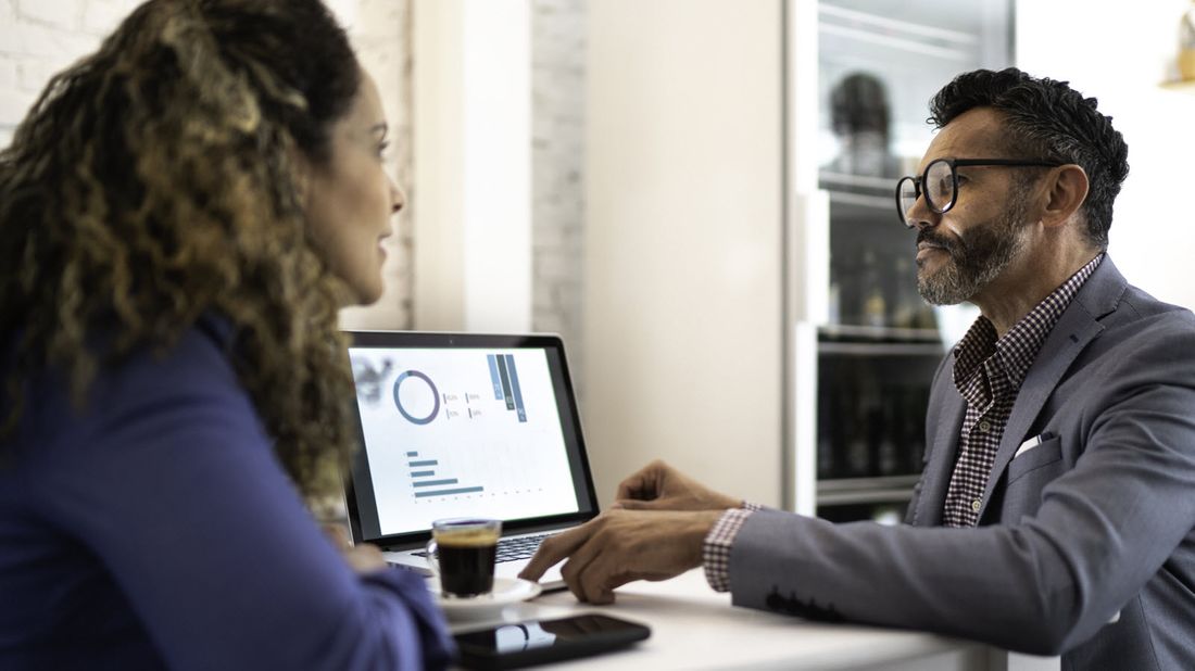 A financial advisor discusses interval funds with a client