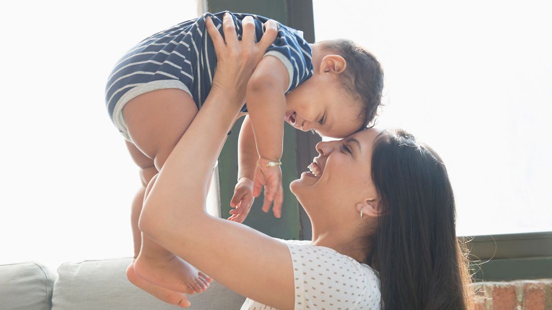 smiling mother holding baby