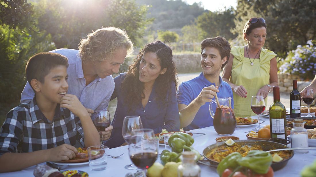 Family having dinner and discussing historic wealth transfer opportunity.