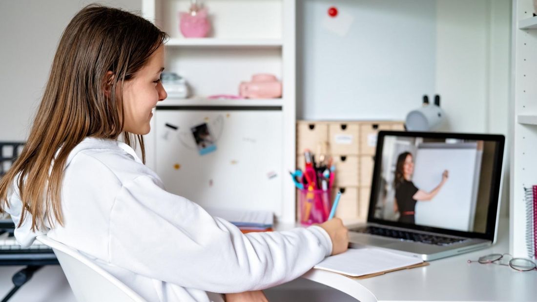 Teenage girl remote learning from teacher on laptop