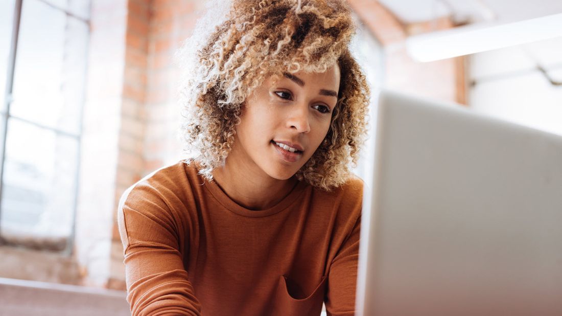 Woman looking a computer taking a life insurance quiz.