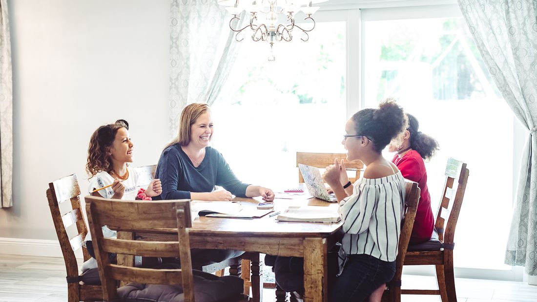 instructor teaching three female students in learning pod