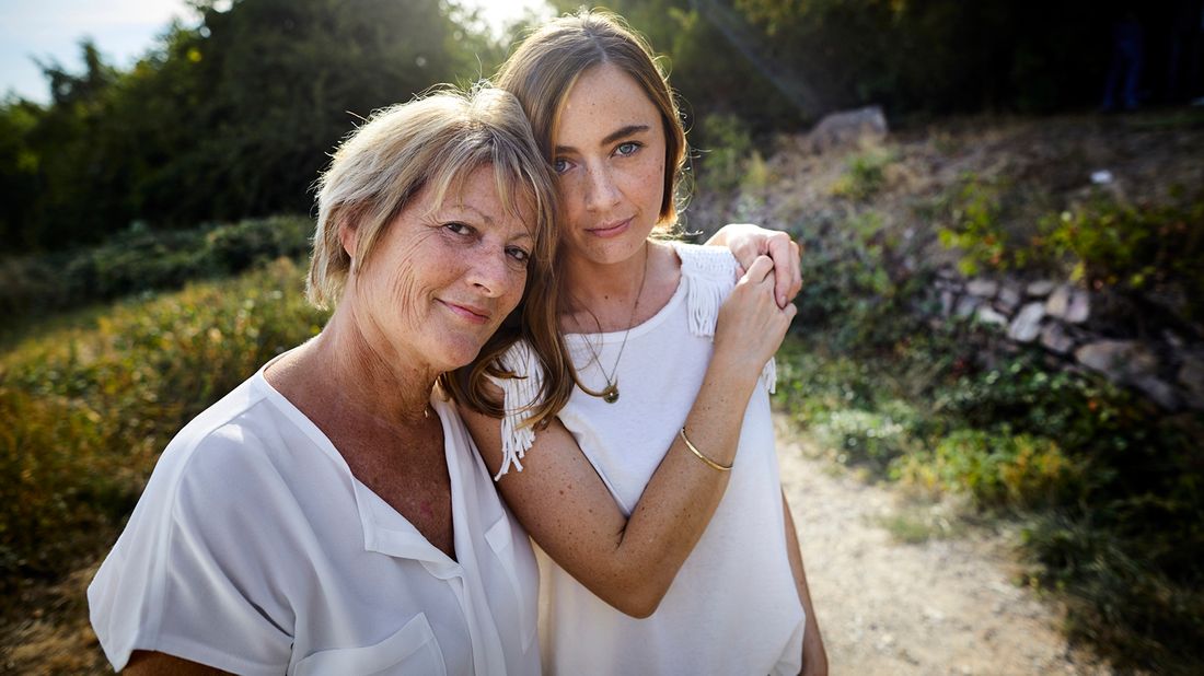 grandmother and granddaughter standing on path outside