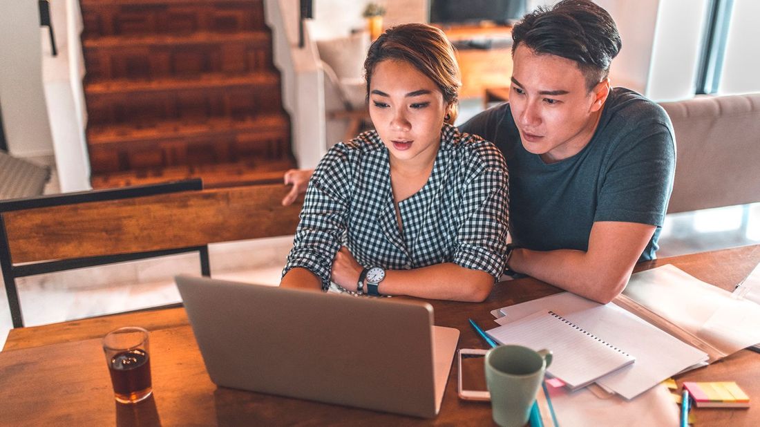couple exploring refinancing on laptop