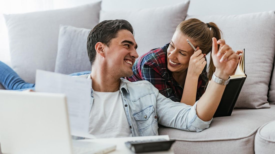 Couple looking at each other and discussing moves to maximize their tax refund