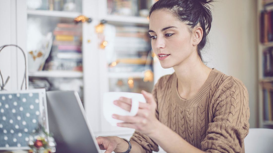 young woman using computer at home