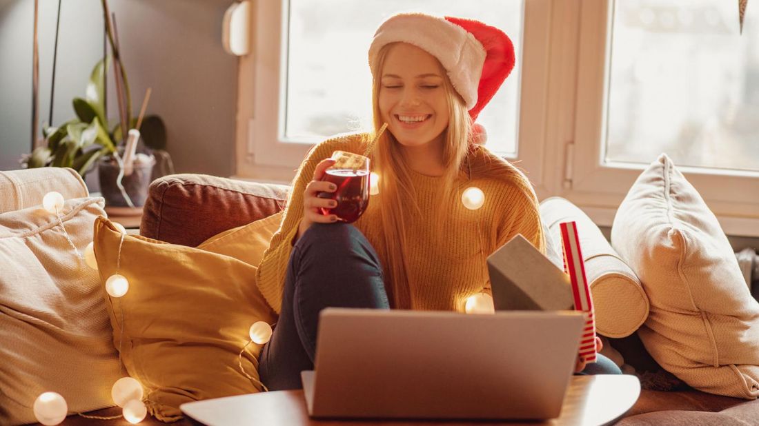 Woman enjoying virtual office party with gifts