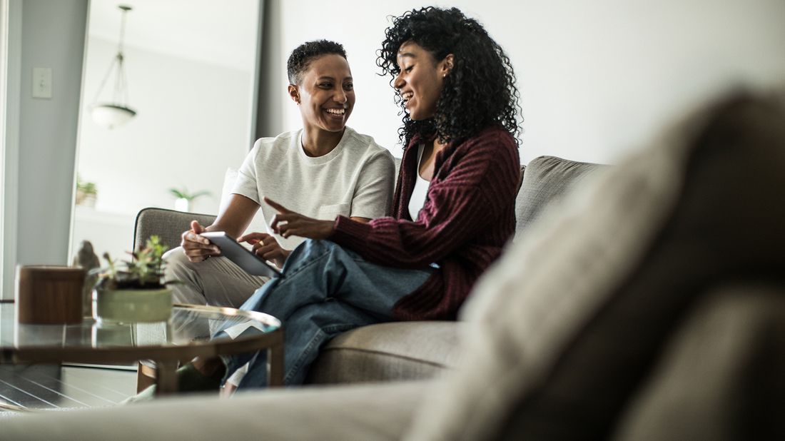 couple sitting on couch at home talking