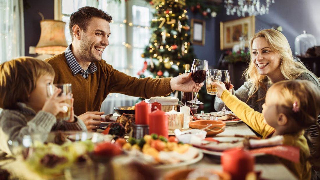 Family toasting each other at a dinner table 