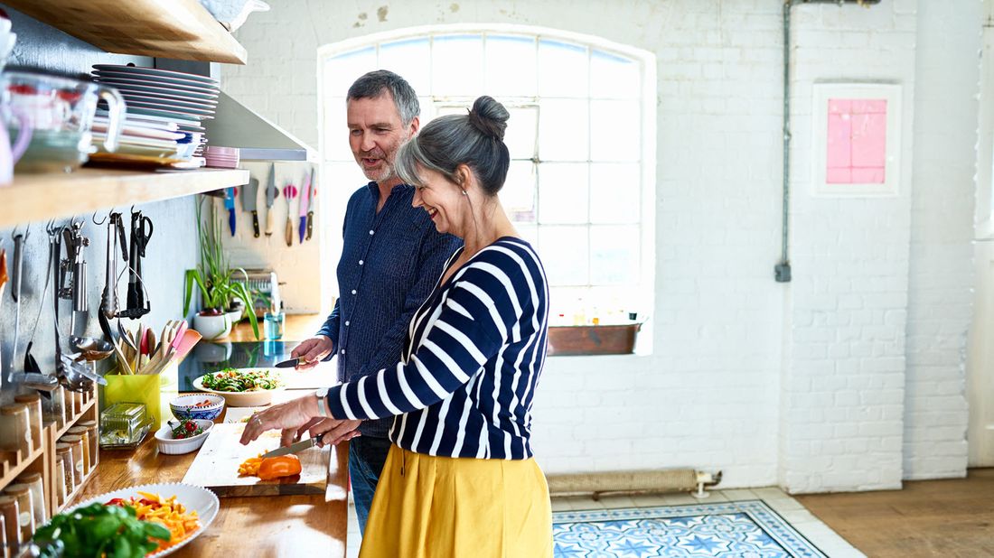 A retired couple in the kitchen discussing the role of financial planning in retirement