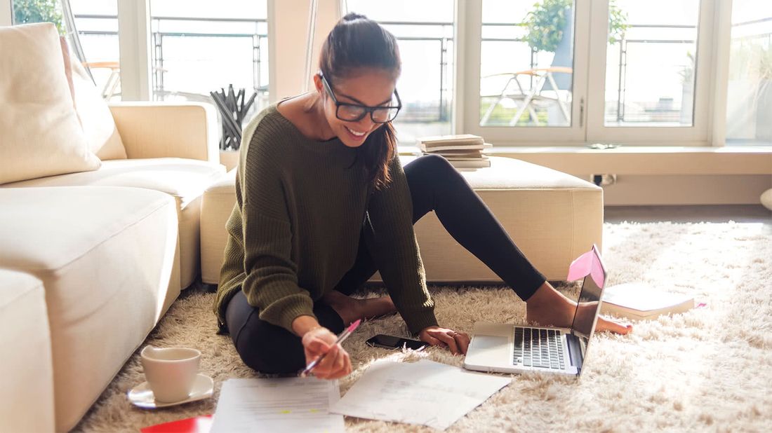 Woman reviewing her credit reports to boost her credit score