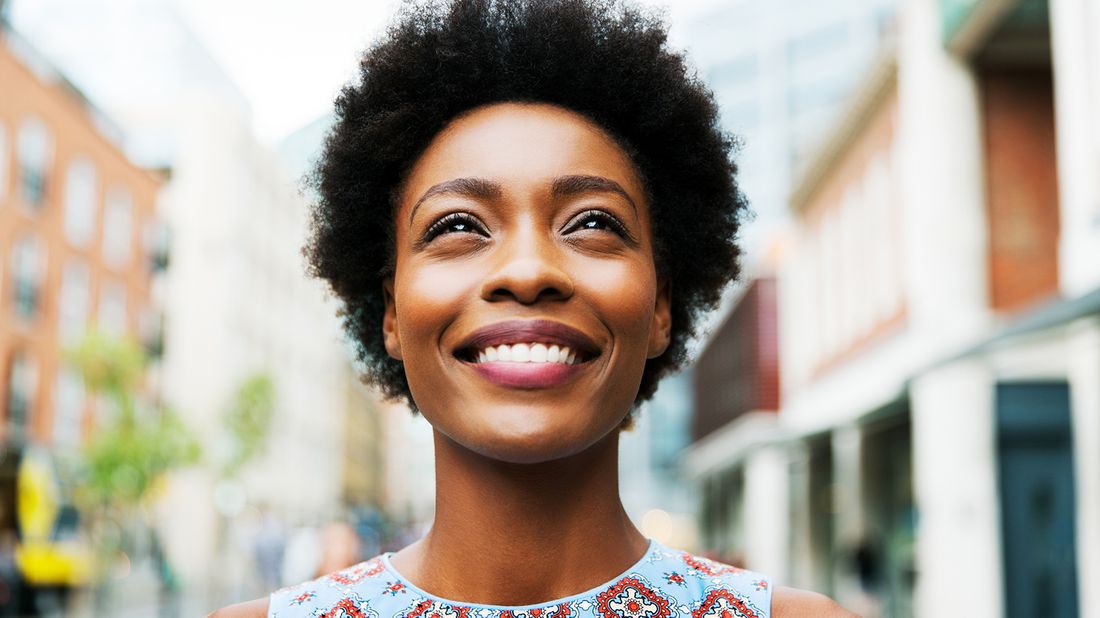 woman smiling up while looking up