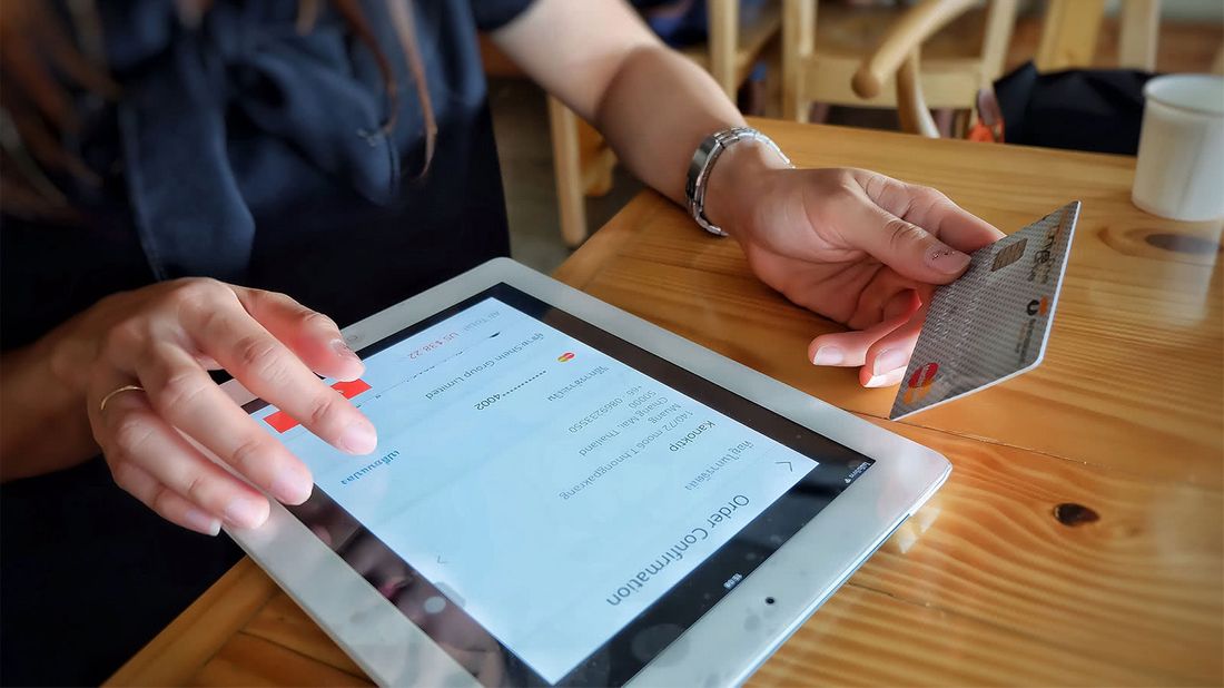 Woman shopping online using a store credit card