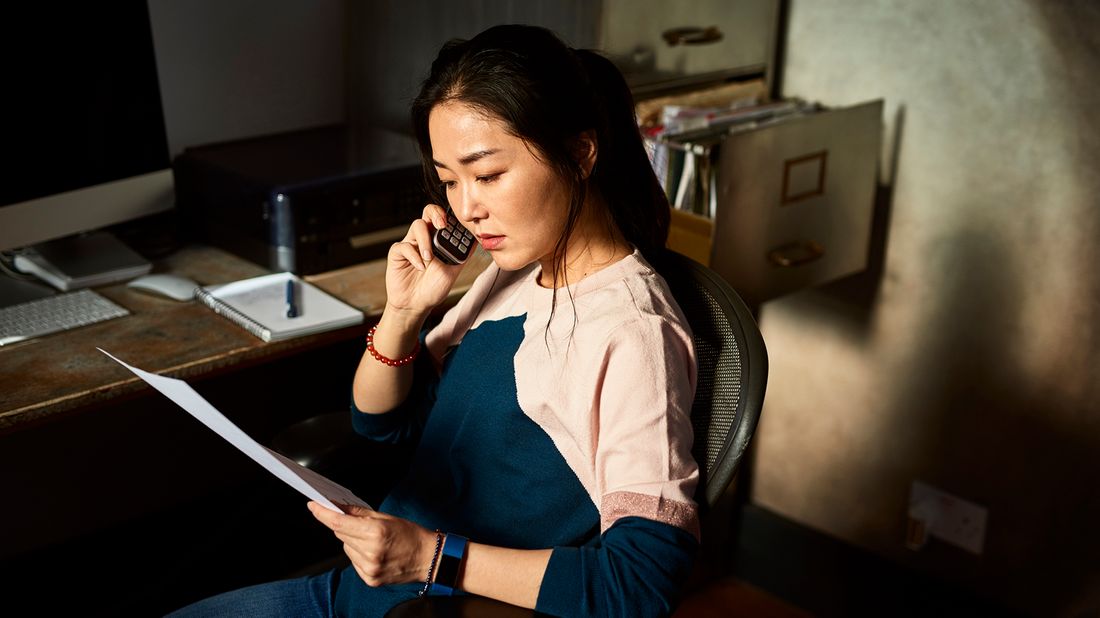 Woman on phone managing debt during covid.