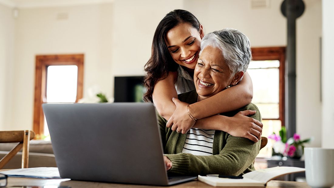 adult daughter hugging older parent