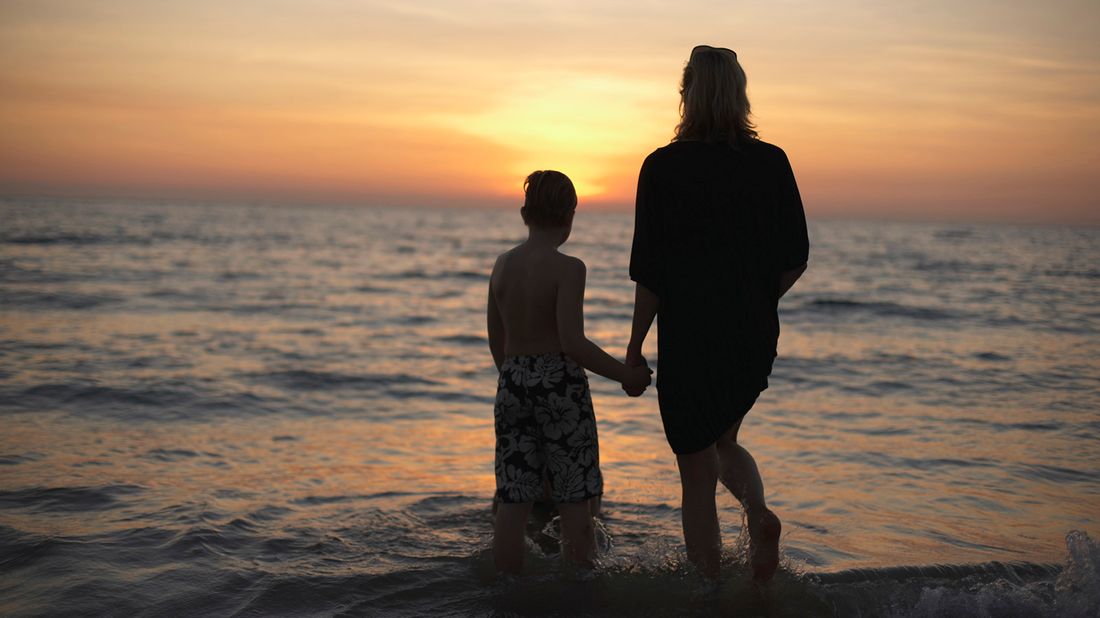 mother and son looking at sunset