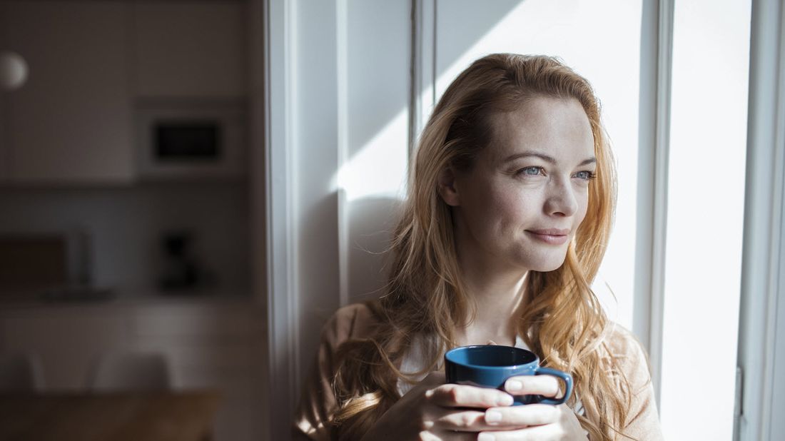 Woman drinking coffee wondering how long does long-term disability last.