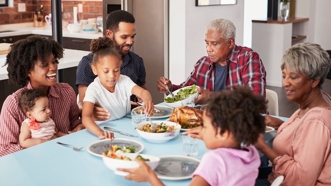 Parents and grandparents having dinner together during pandemic