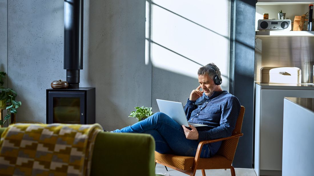 Man sitting in a chair in his loft researching can I avoid paying taxes on my 401(k) withdrawal.