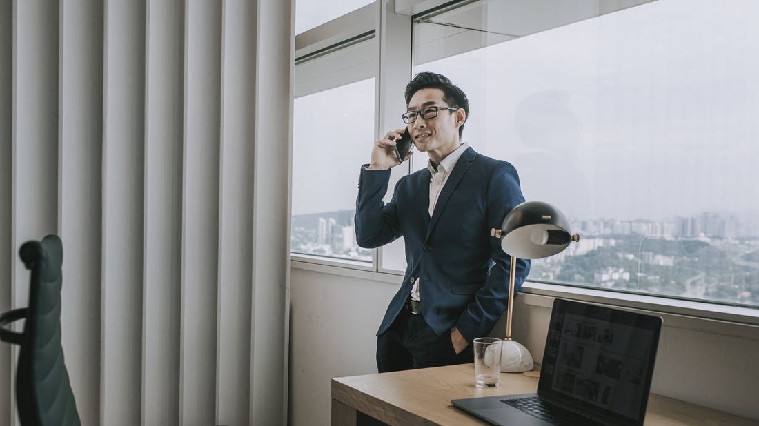 a man speaking with a potential wealth manager on the phone