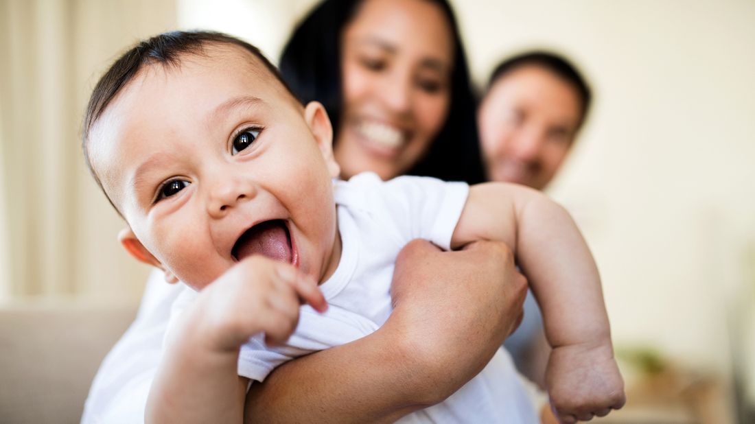 Baby with parents who will benefit from American Rescue Plan Act