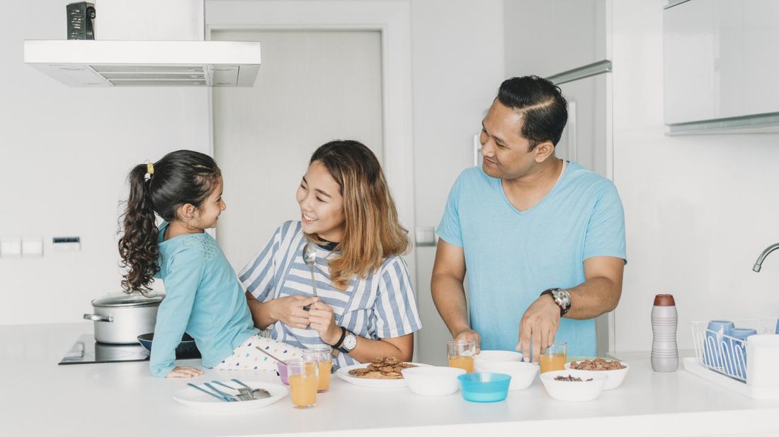 family on a budget making breakfast at home