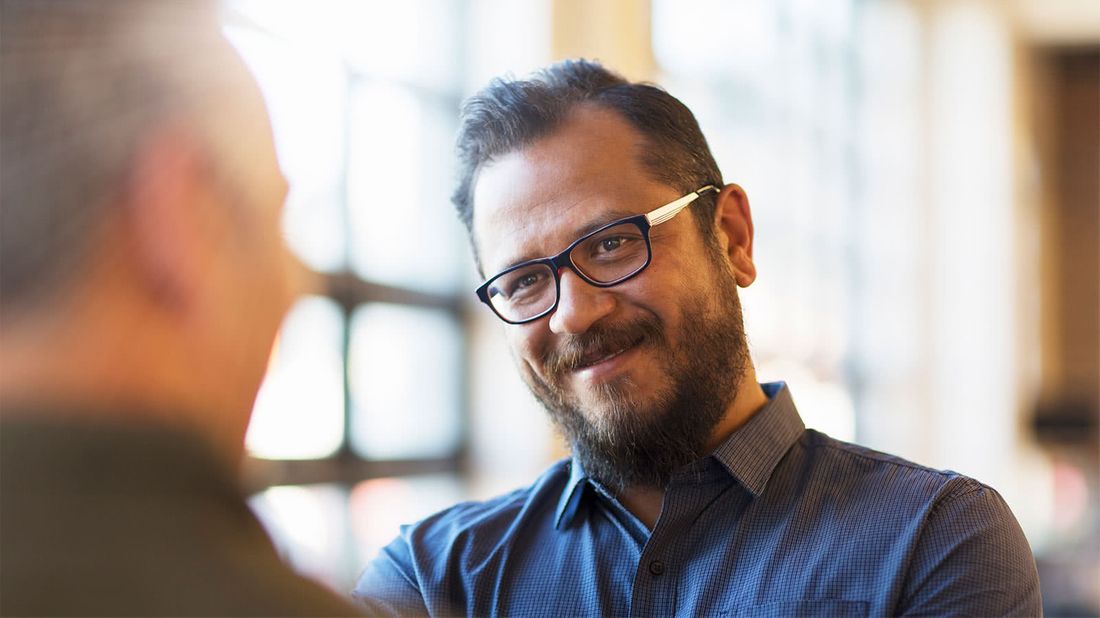 Two friends talking about diversified investing over coffee