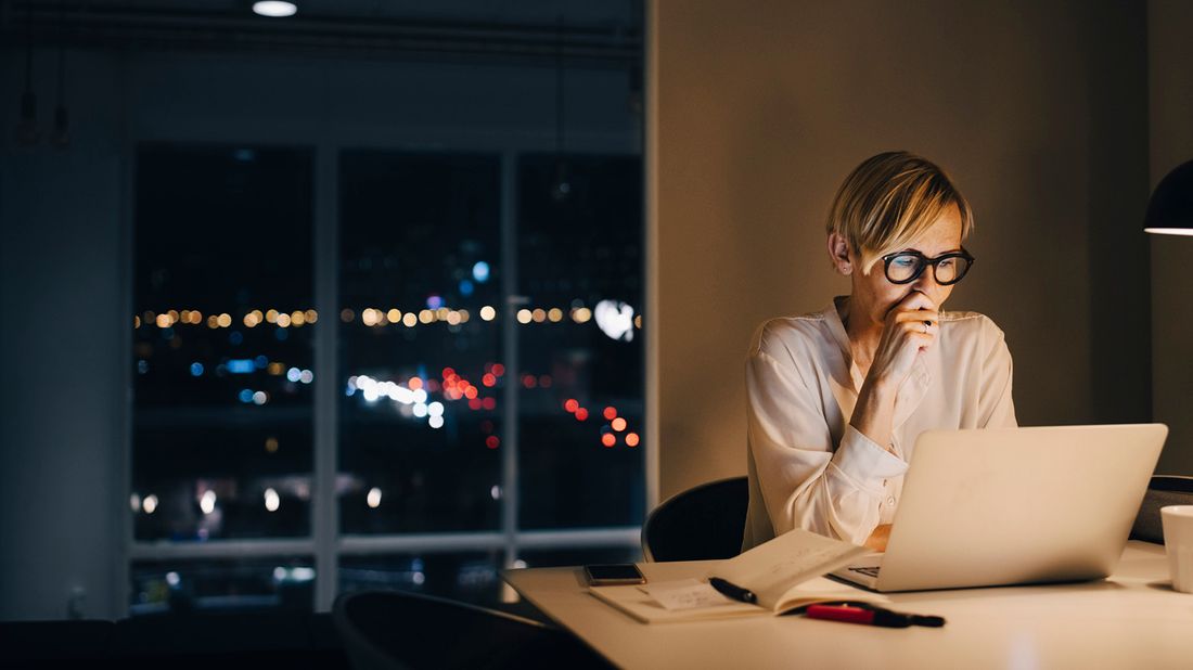 woman using laptop while managing her stress