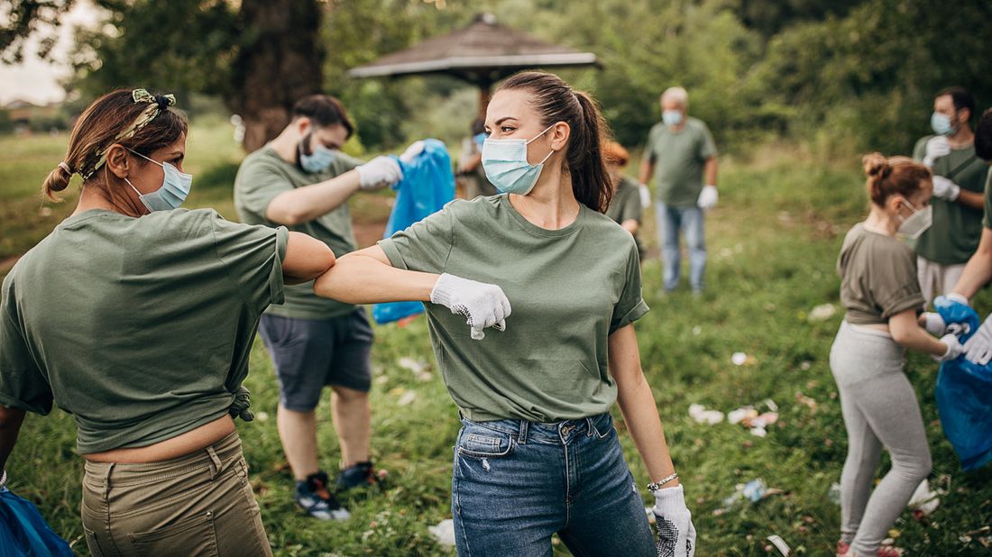 Volunteers cleaning up litter in a park