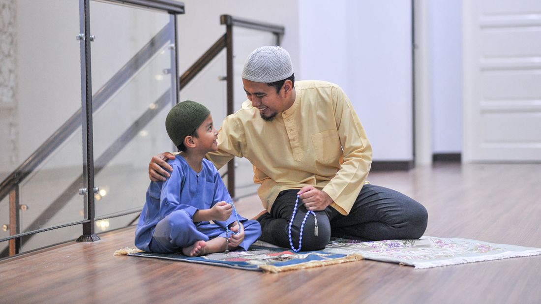 A father and son pray together