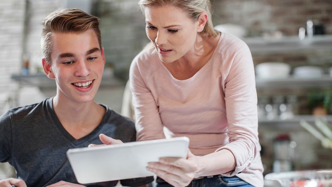 mother and son looking at tablet