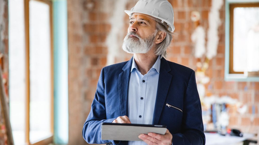 A high-net-worth individual overseeing a construction site