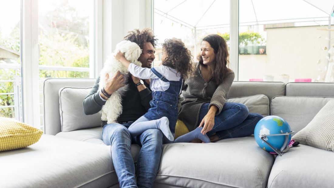 parents and child having fun in living room 