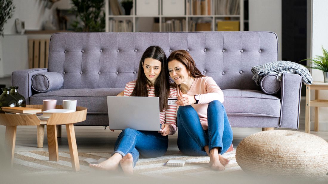 mother teaching daughter how to use credit cards responsibly