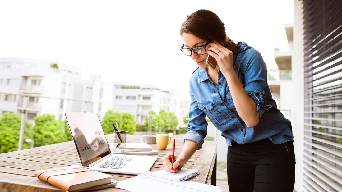 woman working as a freelancer on balcony