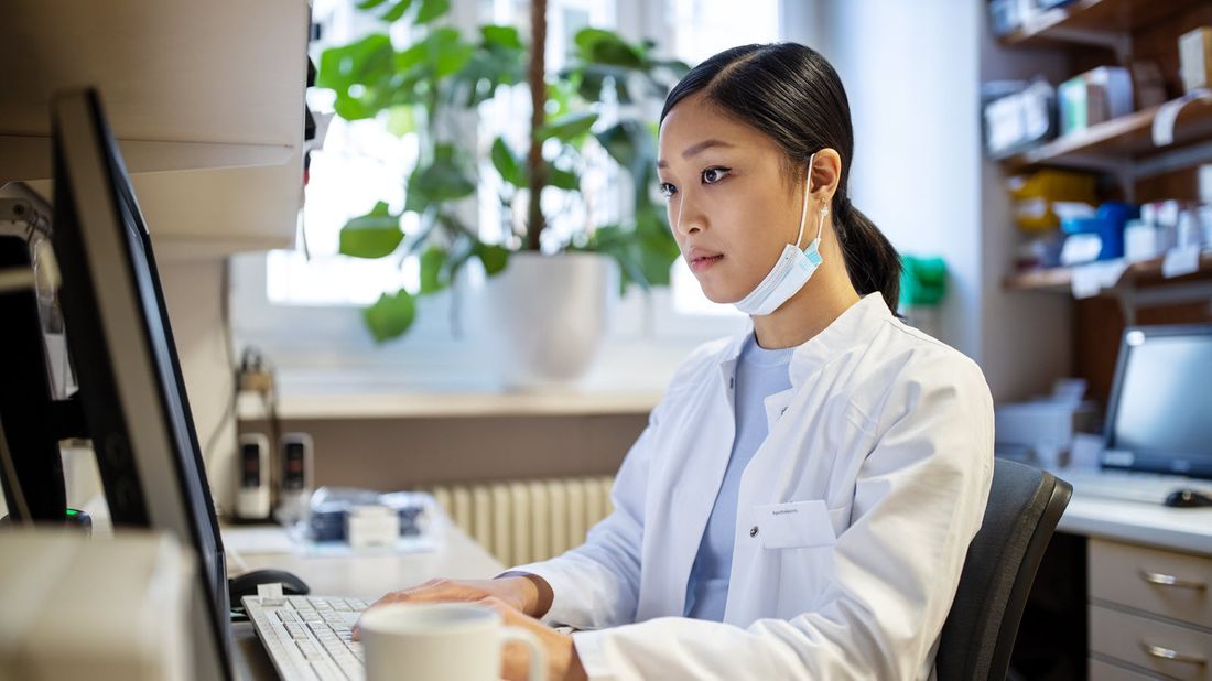 Woman at a computer researching if group life insurance is enough