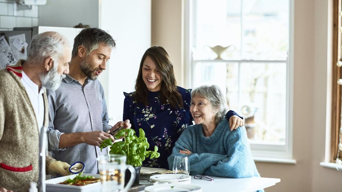 Adult kids making dinner for their parents wondering about life insurance for parents